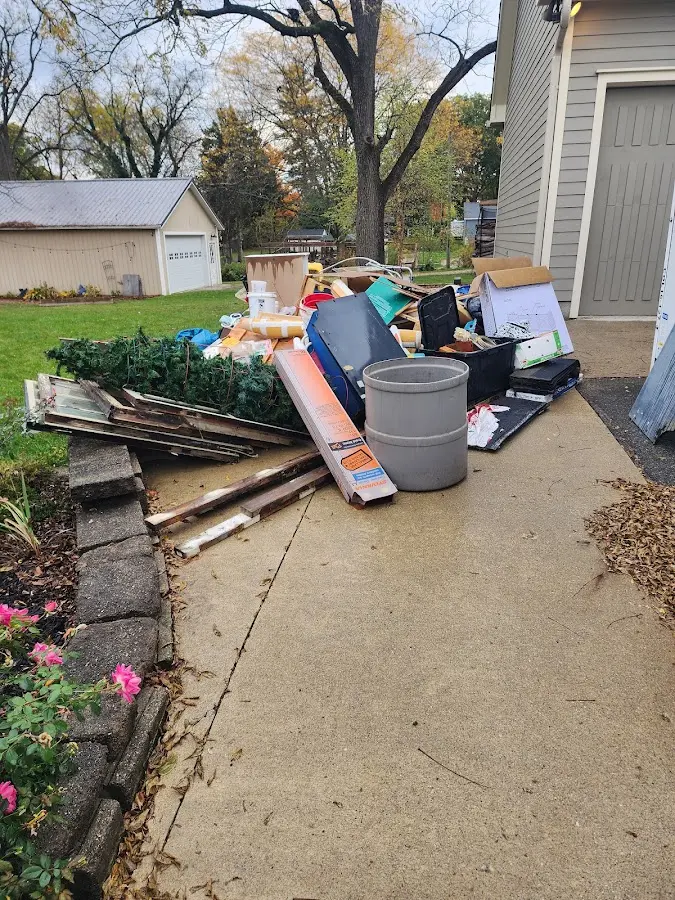 Dumpster being loaded with debris for 12 Yard Dumpster Rental in Williston Park
